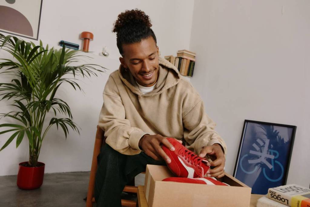 man receiving sneakers that he bought on Vinted