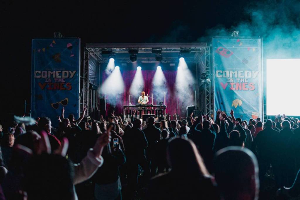 A stage lit up at night at Comedy in the Vines.