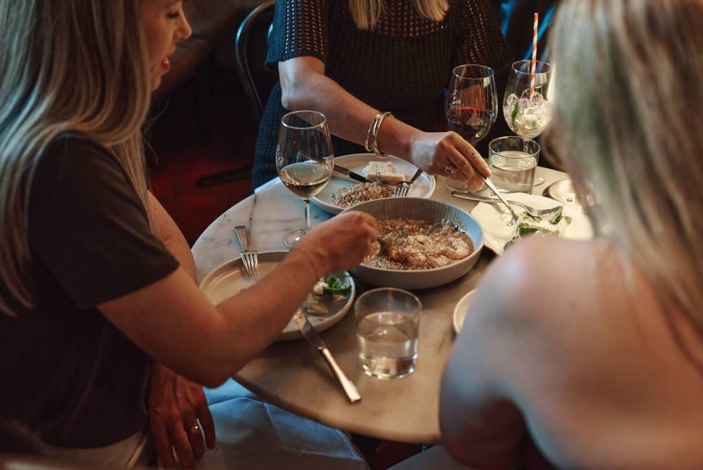 people eating a share plate from Bar Lourinha