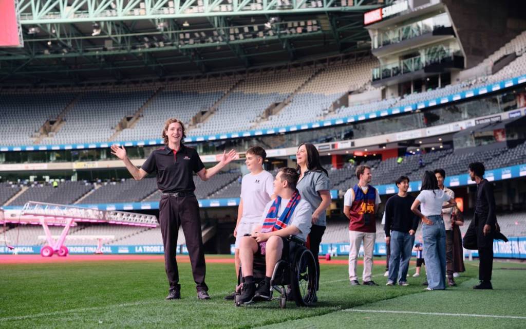 tour guide with visitors on the field at Marvel Stadium