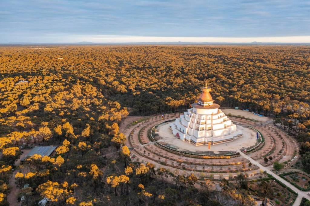 The Great Stupa of Universal Compassion seen from above, surrounded by bushland in Bendigo