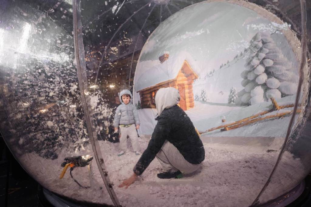 people playing in a snow globe at Queen Victoria Market