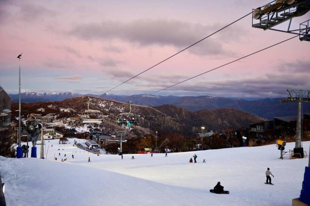 people skiing at sunset in Mt Buller