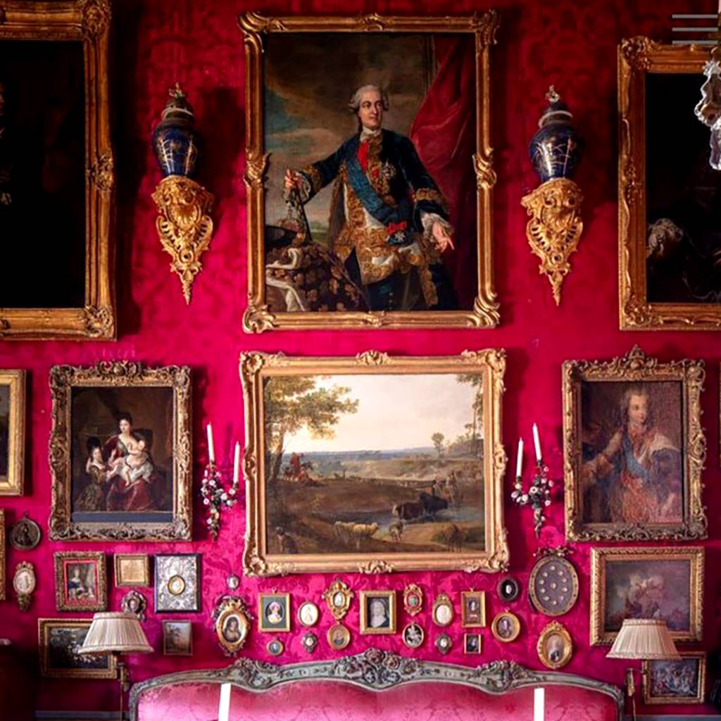 paintings on a red wall inside Barwon Park Mansion