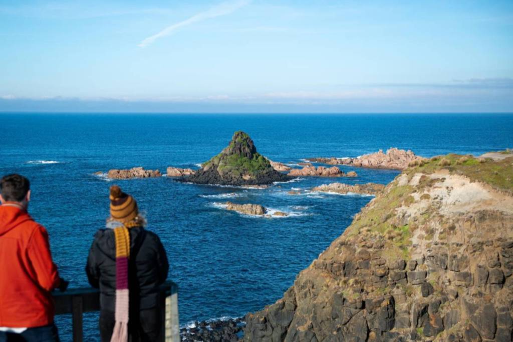 people looking at Pyramid Rock on a winter day
