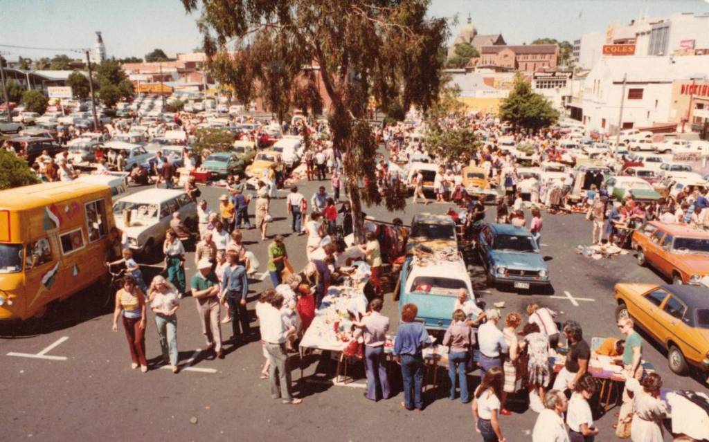 an old photo of Camberwell Sunday Market from the early days, with people browsing the market among old cars