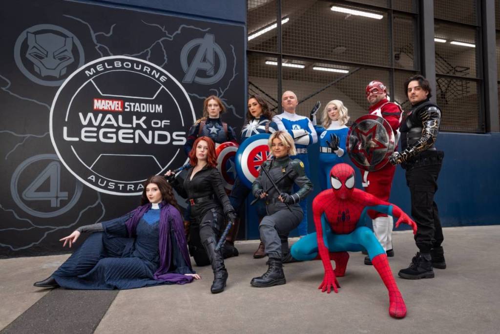 marvel characters posing in front of a sign that says Marvel Stadium Walk of Legends