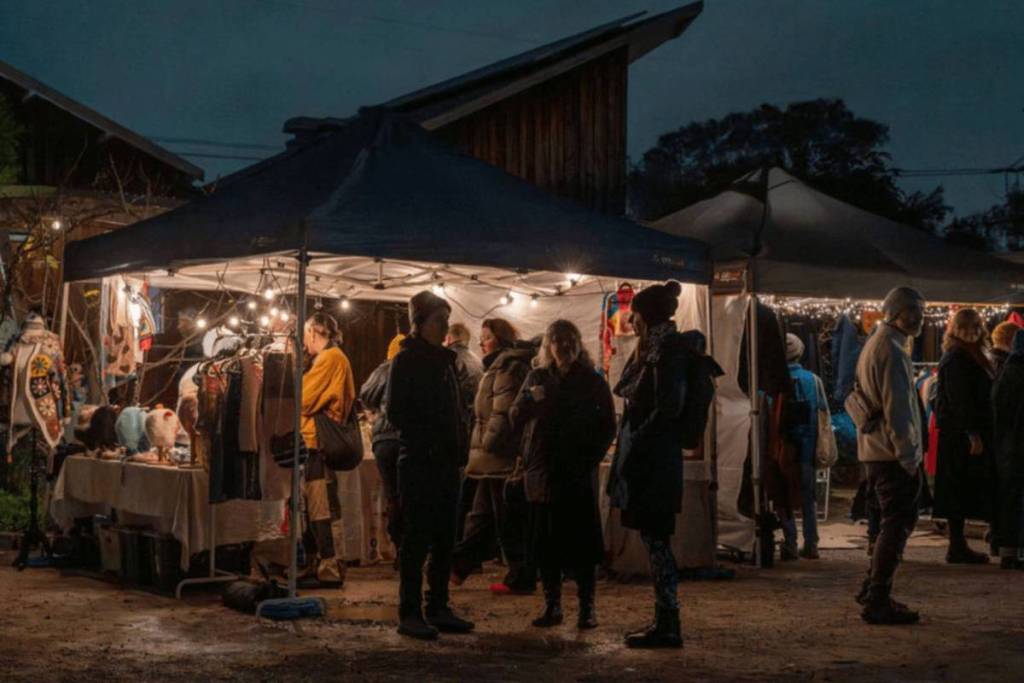 people having a chat outside a stall at the Winter Twilight Market in CERES Brunswick
