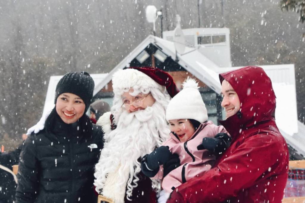family posing with Santa on Lake Mountain for Christmas in July