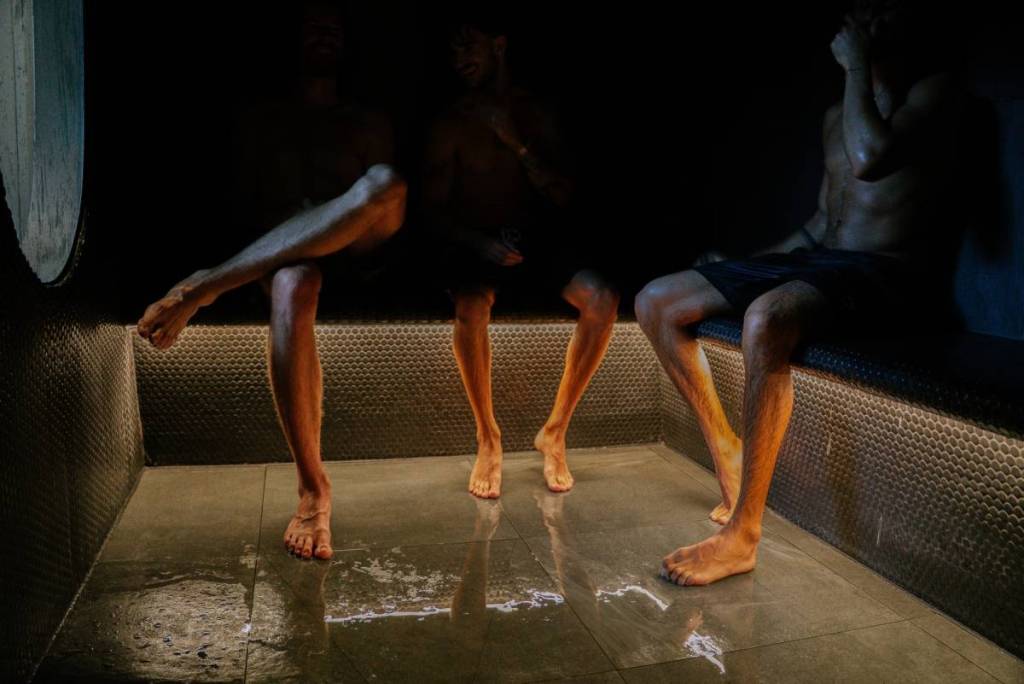 people legs as they sit in a sauna at Navia Bathhouse