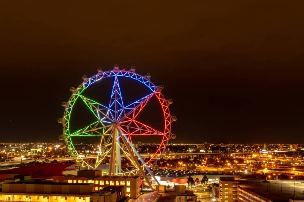 Melbourne Star lit up in a few colours at night