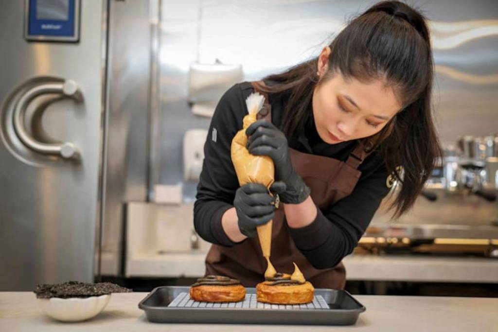 Jess Lemon piping onto pastries in Melbourne