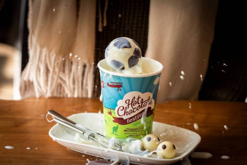 white chocolate soccer ball dropping into a hot chocolate