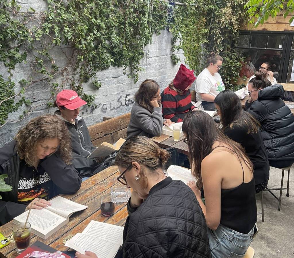 people reading outdoors in a cafe for Book Doof