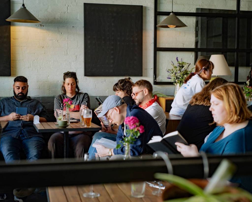 people reading in a cafe for Book Doof