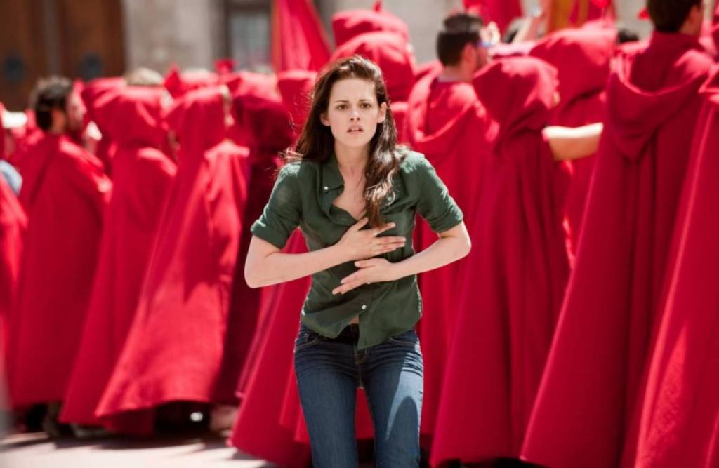Bella about to run in Italy, surrounded by people in red cloaks