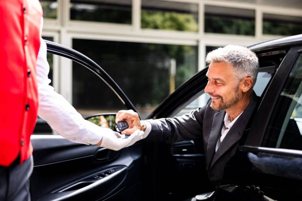 Valet service taking keys from car owner