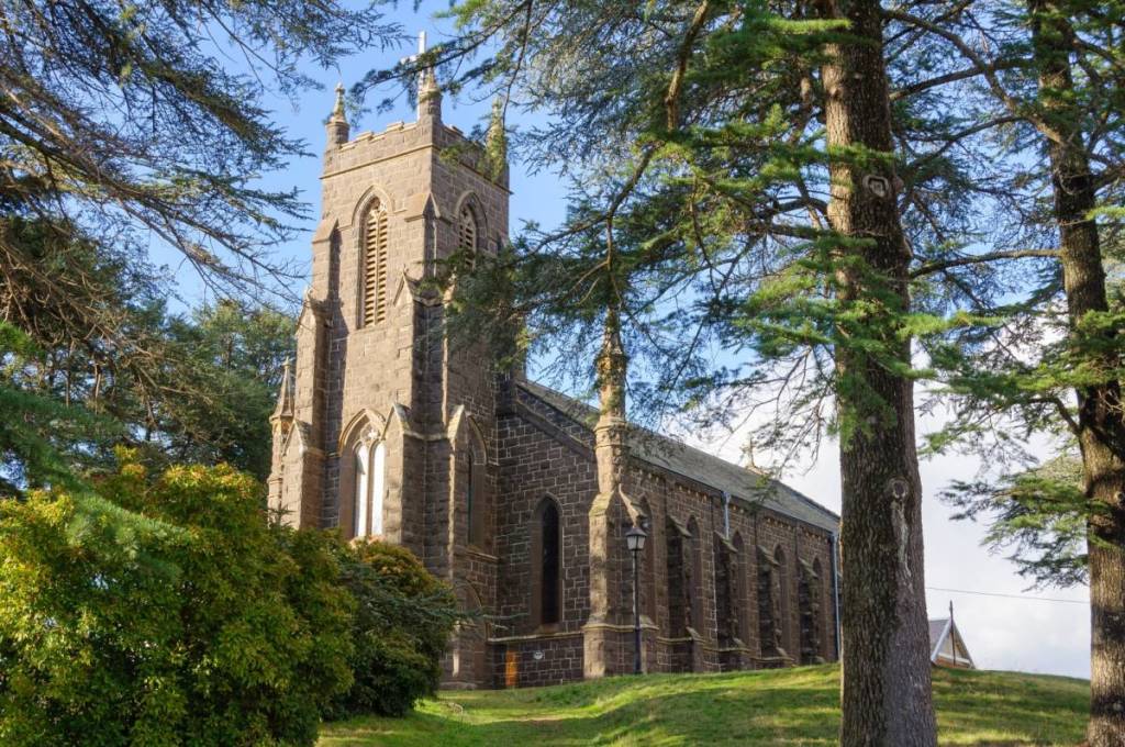 St Paul's Anglican Church in Kyneton, framed by leafy trees