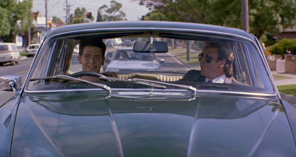 two men in a jaguar car in the film The Big Steal