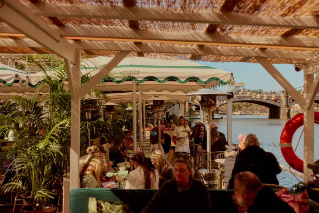 people hanging out under a shady area in Afloat