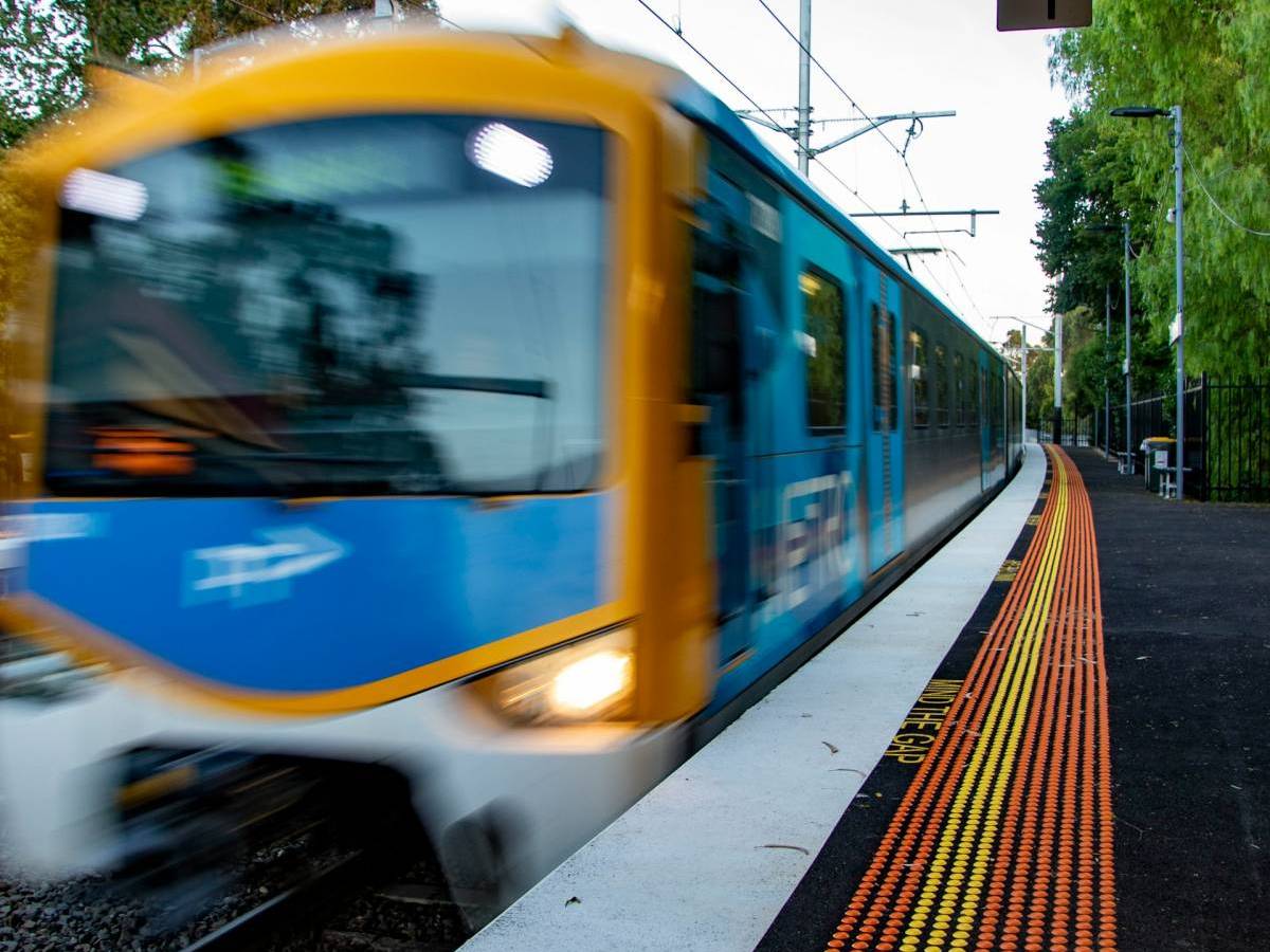 a train in Melbourne zooming past the platform