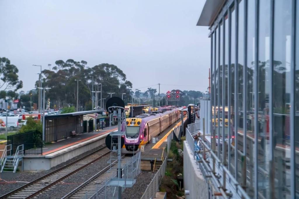 Works at Melton Station as a train goes past