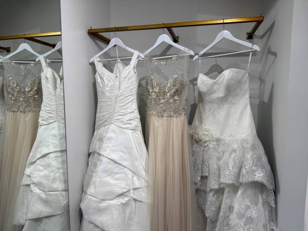 three donated dresses in a fitting room at Sposa Bride