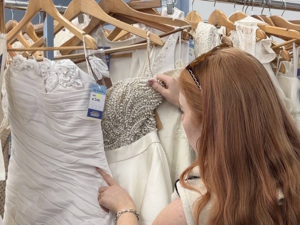 woman browsing through wedding dresses at the Vinnies pop-up