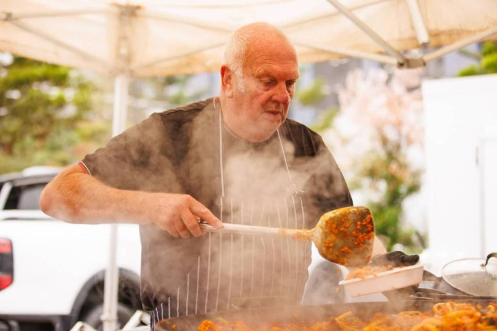 man cooking at Docklands Waterfront Farmers Market