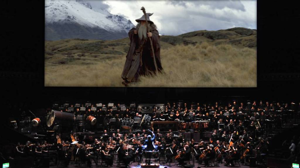 Gandalf on screen, with a live orchestra below