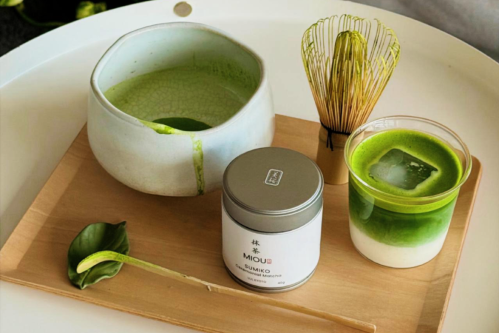 matcha drink and related products on a wooden tray from Miou Matcha