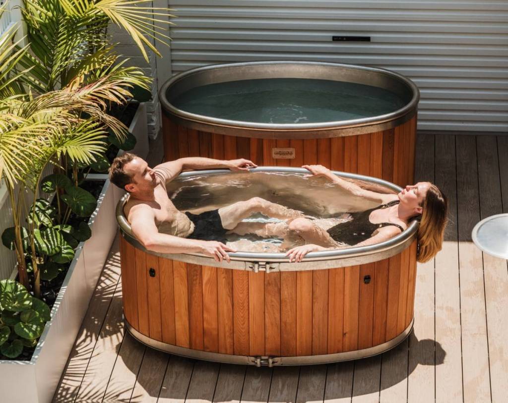 two people relaxing in an outdoor tub at Wildsoul Wellness
