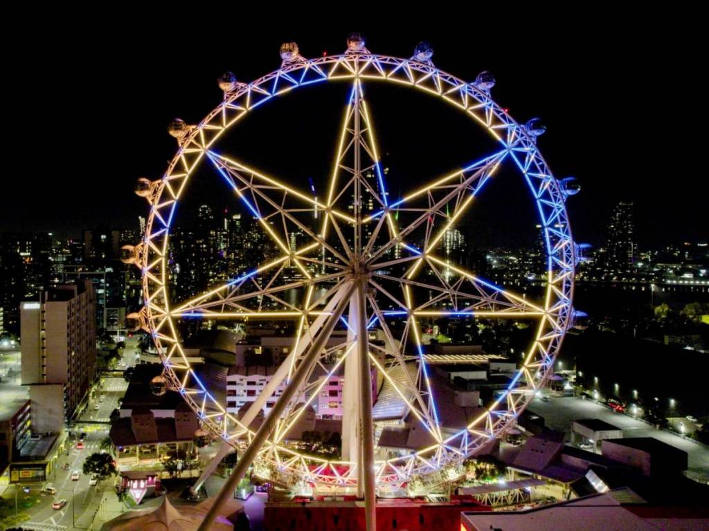 Melbourne Star observation wheel lit up in blue and yellow