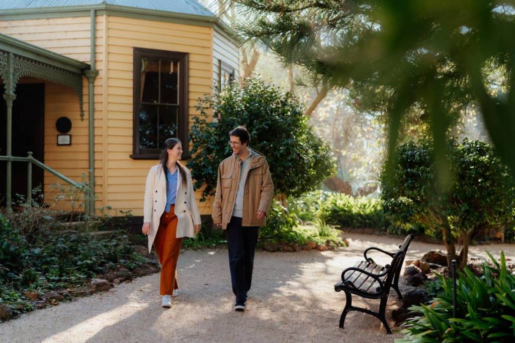 two people walking by cottage and garden at Churchill Island