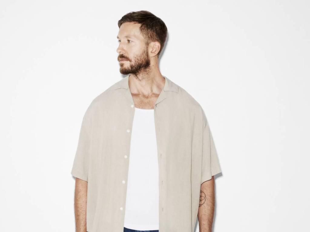 Calvin Harris in front of white backdrop looking off screen