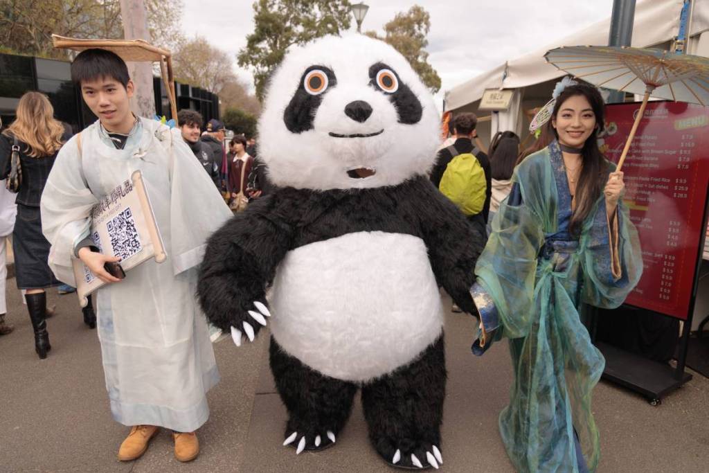 two people in hanfu with a panda at Chinese Traditional Cultural Festival