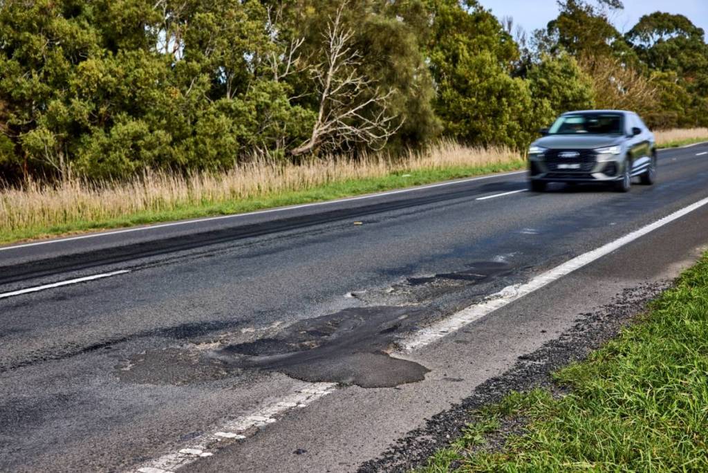 car approaching a pothole on Princes Highway West between Colac and Camperdown