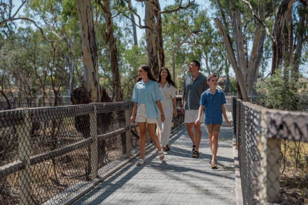 family of four walking along the boardwalk at Horseshoe Lagoon