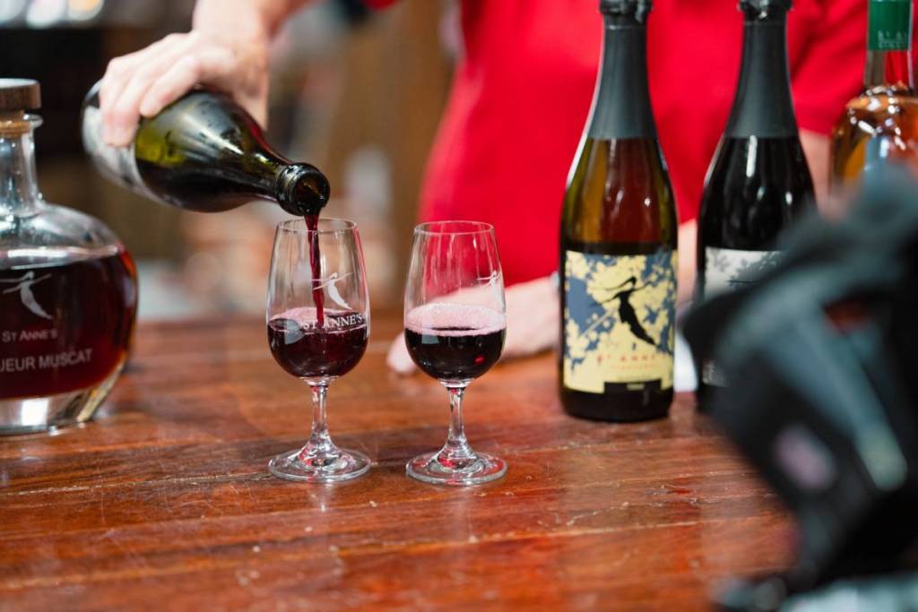 someone pouring wine at St Anne's Winery