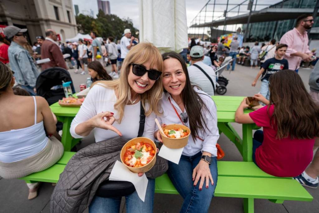 two people enjoying their food outside at Italian Festa & Expo