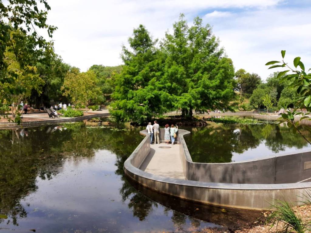 people on sunken walkway into a lake at Wilson Botanic Park