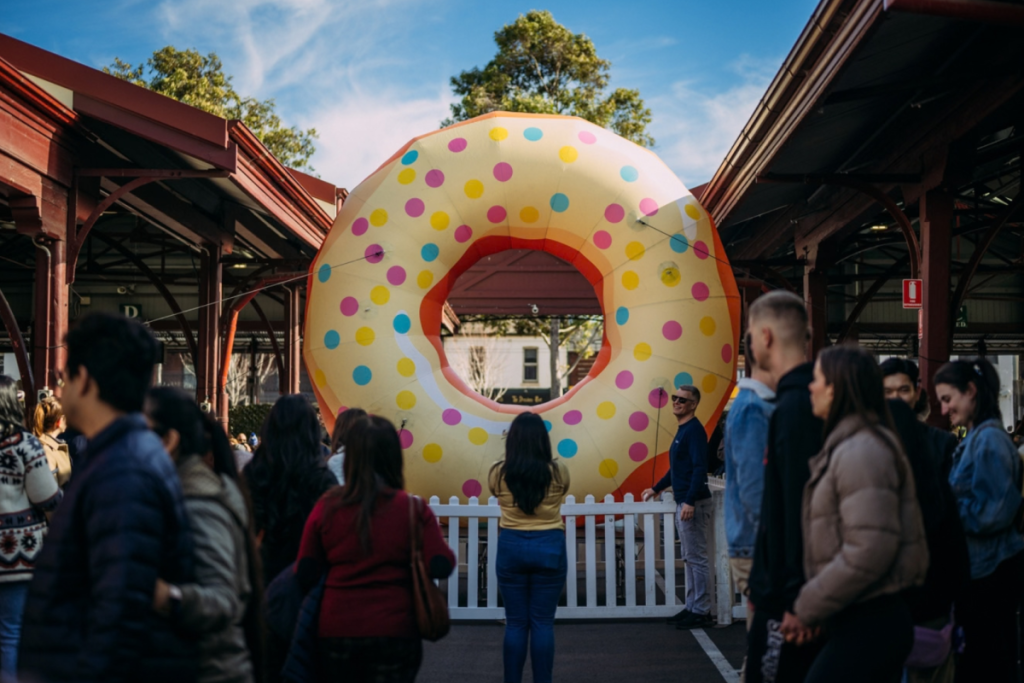 people in front of inflatable donut during festival at Queen Victoria Market