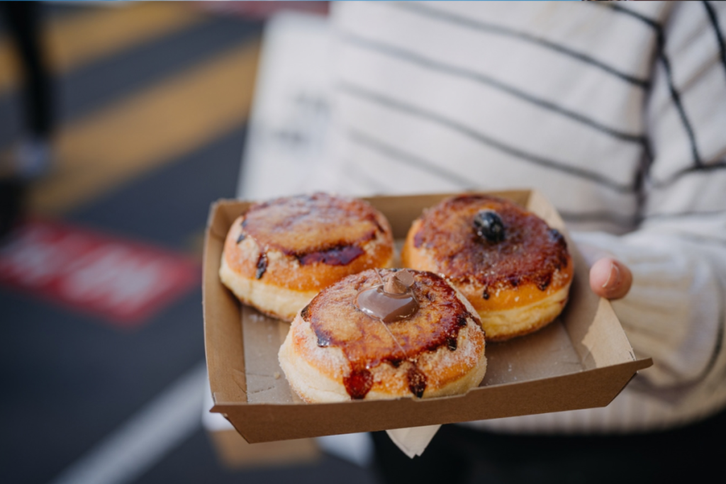 someone holding pack of creme brulee donuts