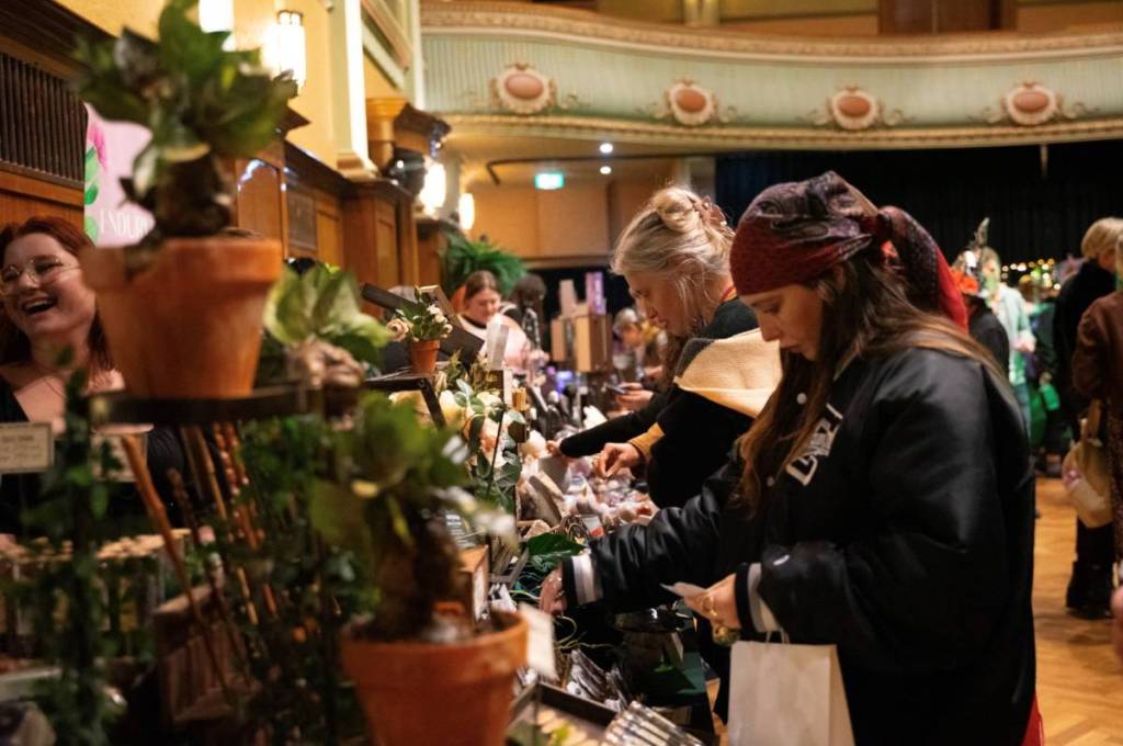 woman looking at items at stall in Witch Market