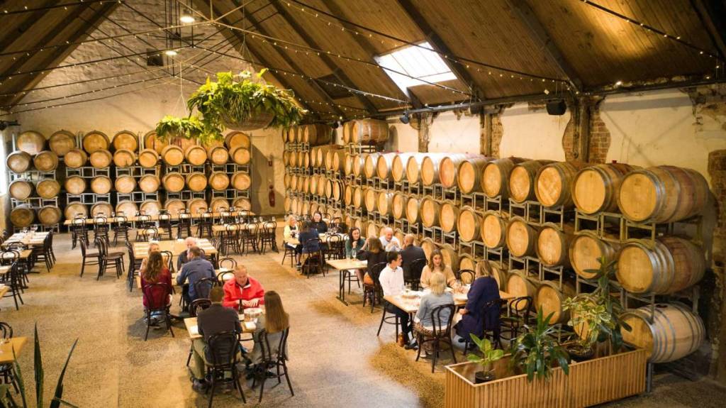 inside restaurant of Provenance Winery, with barrels lined against the walls