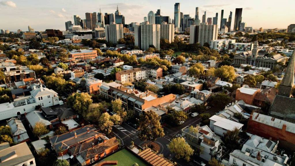 aerial view over houses in Melbourne with city skyline visible