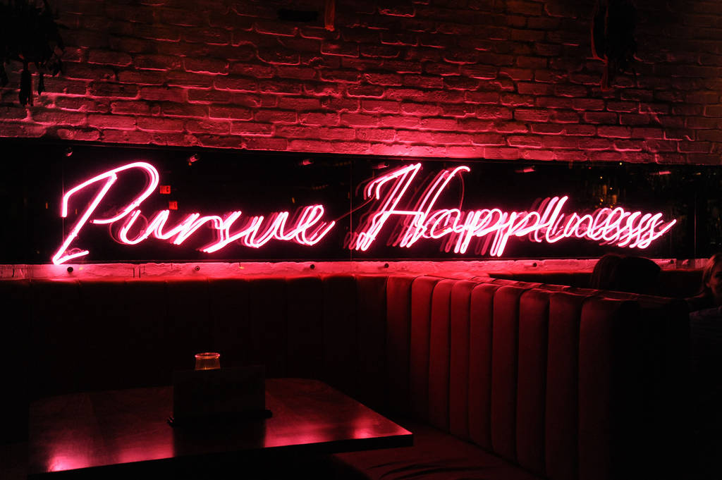 Pursue Happiness neon sign at Sweet Liberty