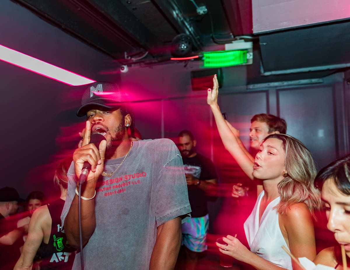 Group of people singing inside a 1-800-Lucky karaoke room