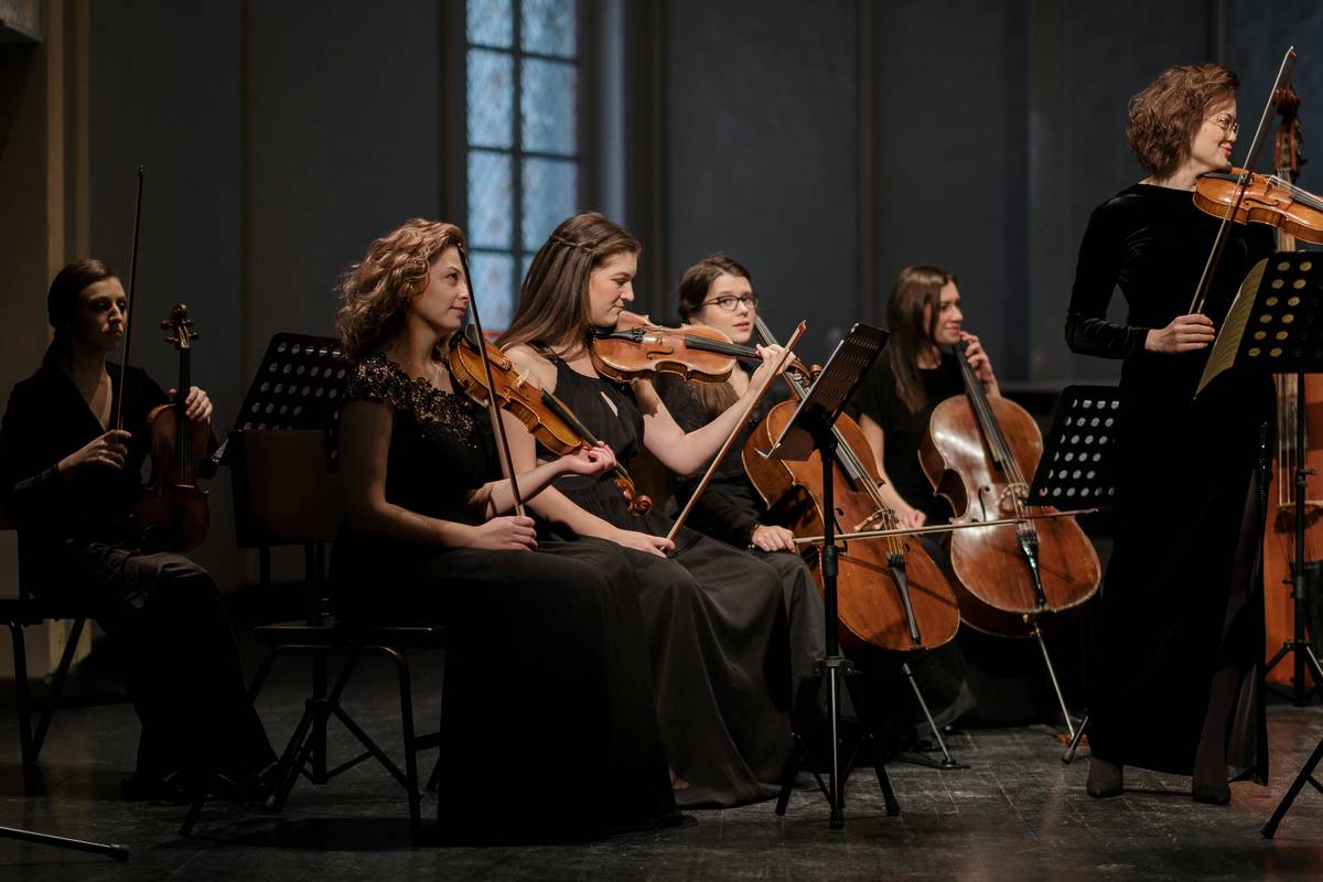 women perform in orchestra