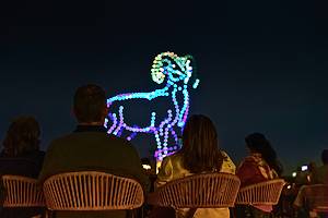 Illuminated drones fly over a string quartet